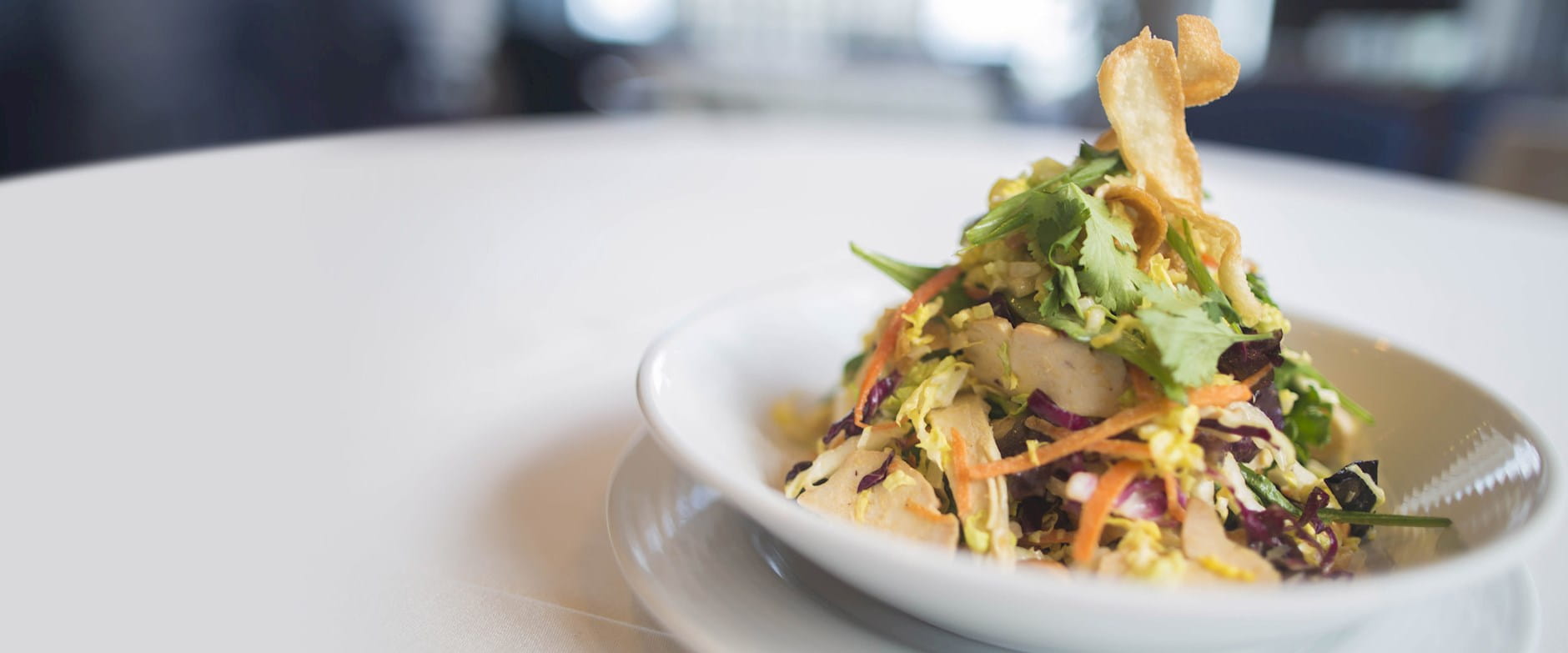 Gourmet chicken salad in a bowl topped with crispy croutons