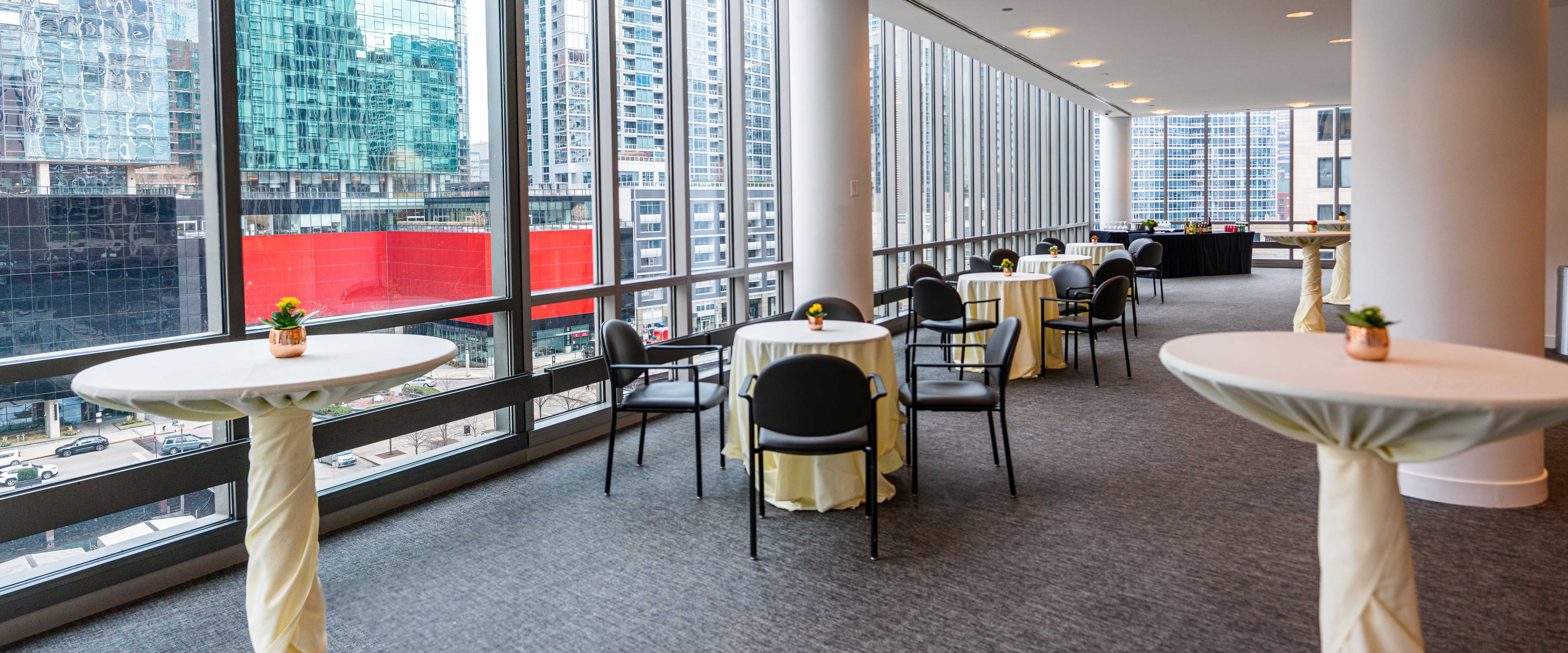Gleacher Center reception area room 650 set with tables and chairs