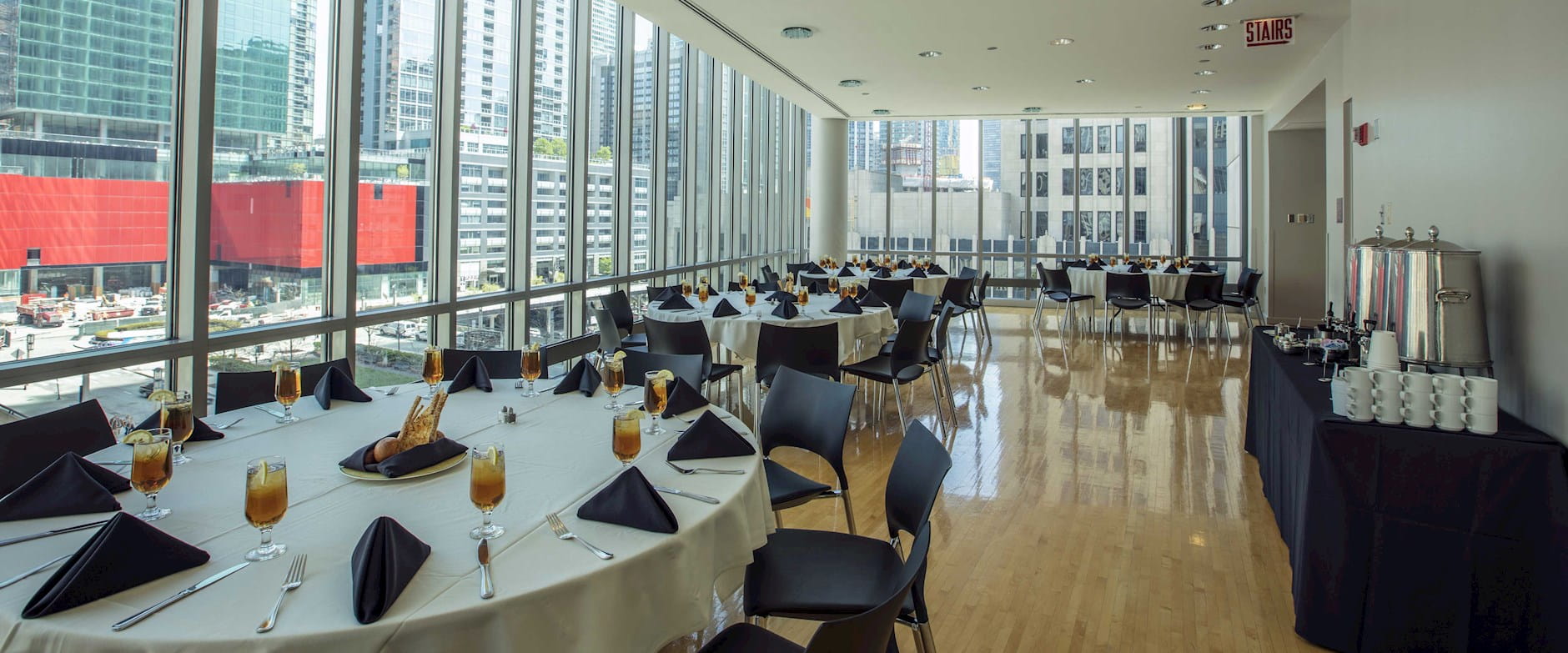 Looking out over the plaza from a small dining room in Gleacher Center with circular tables surrounded by chairs