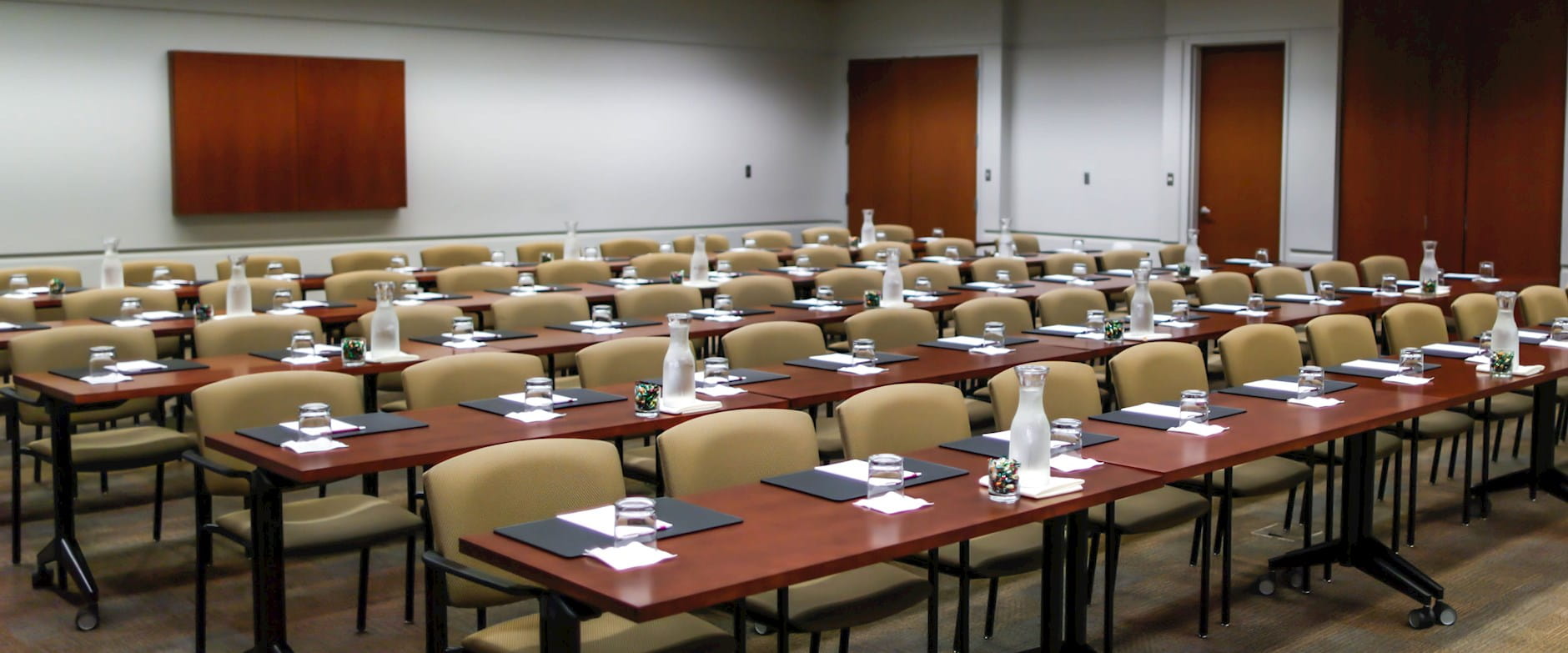 Rows of tables and chairs from the front of an executive meeting room in Gleacher Center