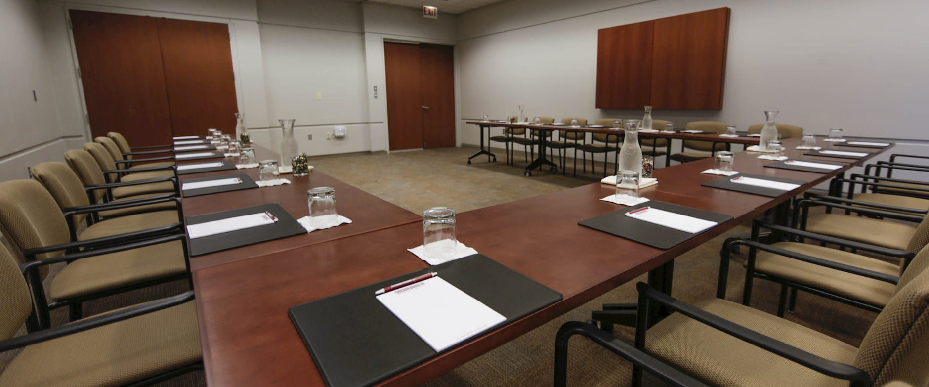 Gleacher Center Executive Meeting Room with warm wooden tables in a U-shape