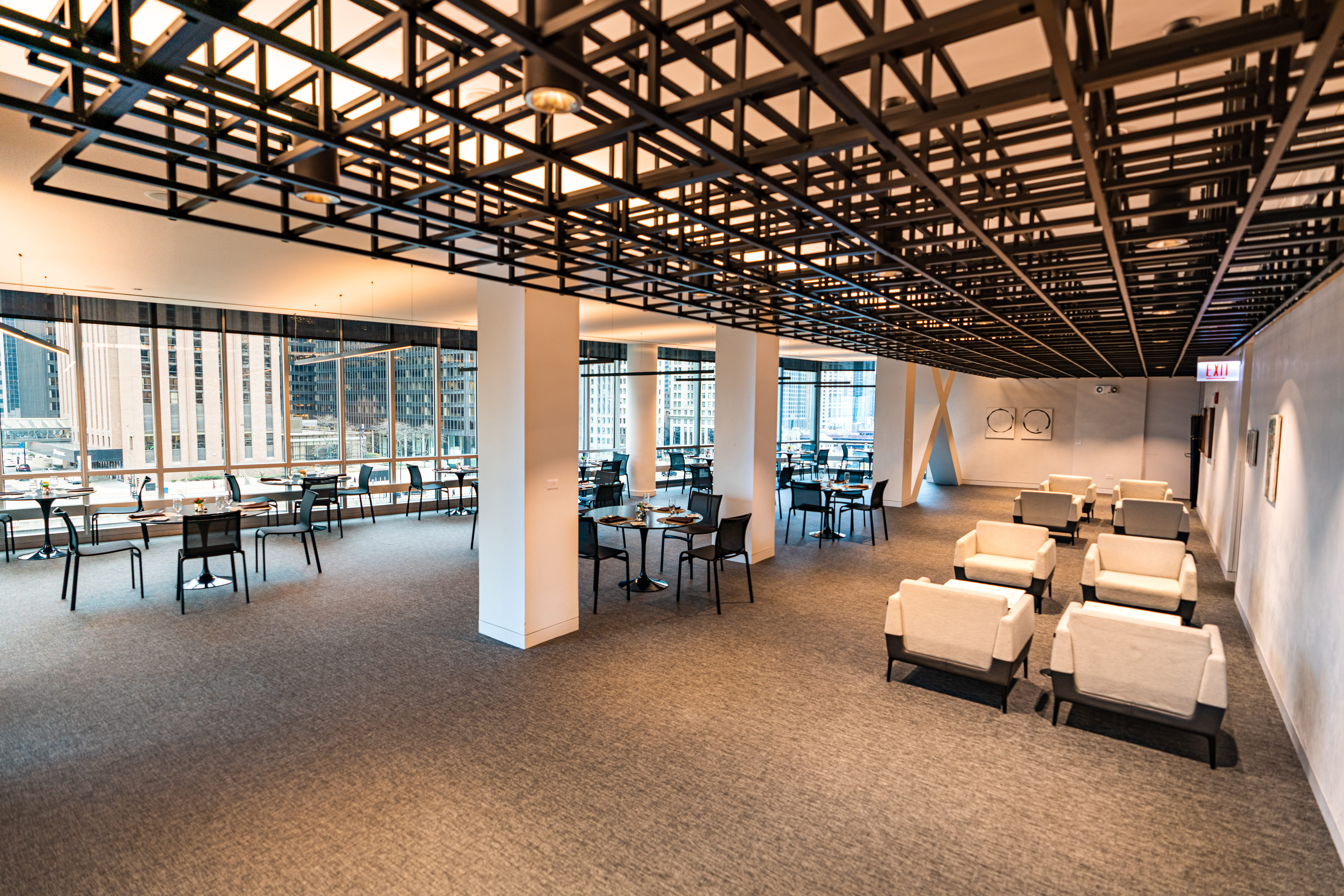 PIMCO Midway club western angle. Lounge chairs to right, and four person dining chairs to the left. 